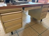 a computer desk with a keyboard and a mouse on it