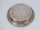 an antique silver plate with a lid on a white table