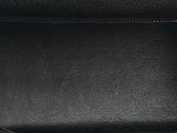 the inside of a black purse with a red handle