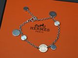 an orange box with a silver bracelet and a coin on it