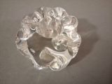 a glass candle holder with a flower design on it