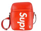 a red bag with a white supreme logo on it