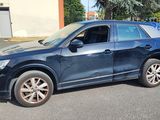 a picture of a blue suv parked in a parking lot