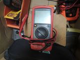 a multimeter sitting on top of a piece of luggage