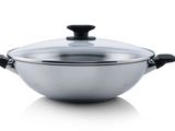 a close up of a pan with a lid on a white surface