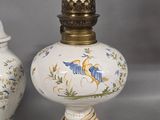 pair of antique porcelain lamps with hand painted birds on them