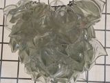 a glass heart shaped object hanging on a wire