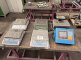 many electronic scales on a table in a factory