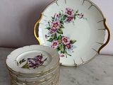 a stack of plates with flowers on them on a table