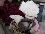 a pile of clothes in a suitcase on the floor