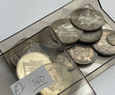 coins in a clear box with a price tag on it