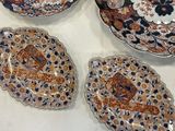 four plates and a bowl are sitting on a table