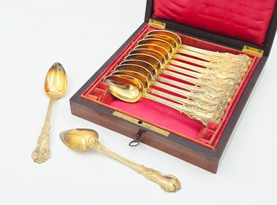 several spoons and spoon rest in a wooden box with a red lining