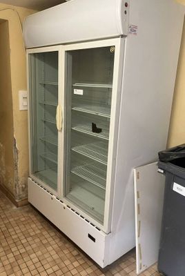 a refrigerator that is in the middle of a kitchen