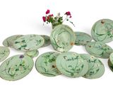 a lot of plates and vases with flowers on them