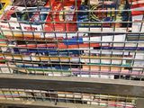 a metal basket full of books in a store