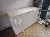 a white refrigerator sitting in the corner of a room
