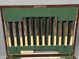 many knives in a case that are sitting on a table