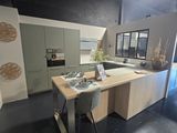 a kitchen with a table and chairs in the middle of the room