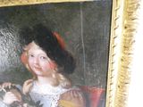 un tableau représentant une petite fille tenant un chat dans la main