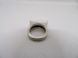 a silver ring sitting on top of a white table