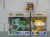 two boxes of pokemon toys sitting on a glass table