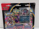 a close up of a package of pokemon cards on a white surface