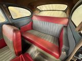 a red and black seat in the back of a car