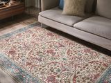 a living room with a couch and a rug on the floor