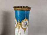 a blue and white vase with gold decoration on it