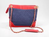 a red and blue purse with a chain strap