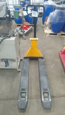 un chariot élévateur posé sur une palette dans un entrepôt