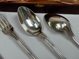 four spoons and a fork on a table
