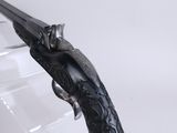 a gun that is sitting on top of a glass table