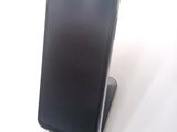 a cell phone that is sitting on top of a stand
