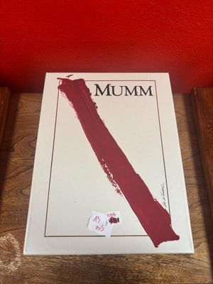 a book on a table with a red wall in the background
