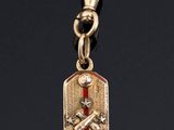 a close up of a keychain with a skull and crossbone on it