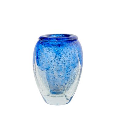 a blue glass vase with bubbles in it on a white background