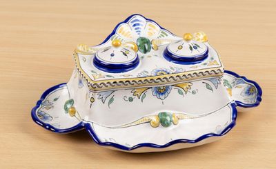 a blue and white plate with a blue and yellow lid