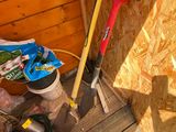 a picture of a shovel and some tools on a wooden floor