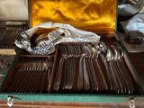 silverware in a case on a table with other silverware in it