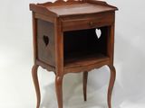 a small wooden table with a heart on it