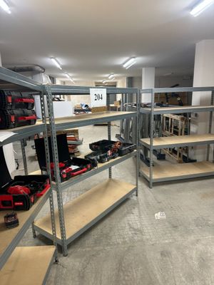 many shelves with tools on them in a room