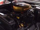 a car engine with the hood up and the hood down