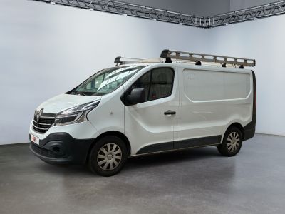 a white van parked in a room with a ladder on the roof