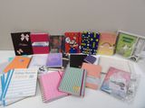 many different types of notebooks sitting on a table
