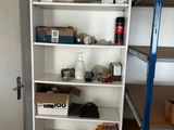 a tall white bookcase with many items on it