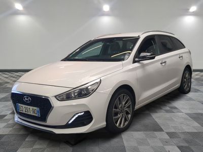 a white car is parked in a room with a checkered floor