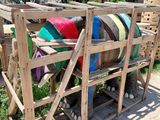 a wooden pallet with a bunch of colorful pillows on it
