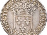 a silver coin with a crown on top of it